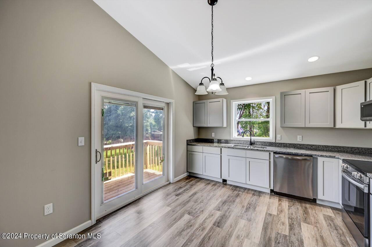 551 Back Street Scranton, PA 18504 - Photo 16 of 47 a large kitchen with kitchen island white cabinets and stainless steel appliances