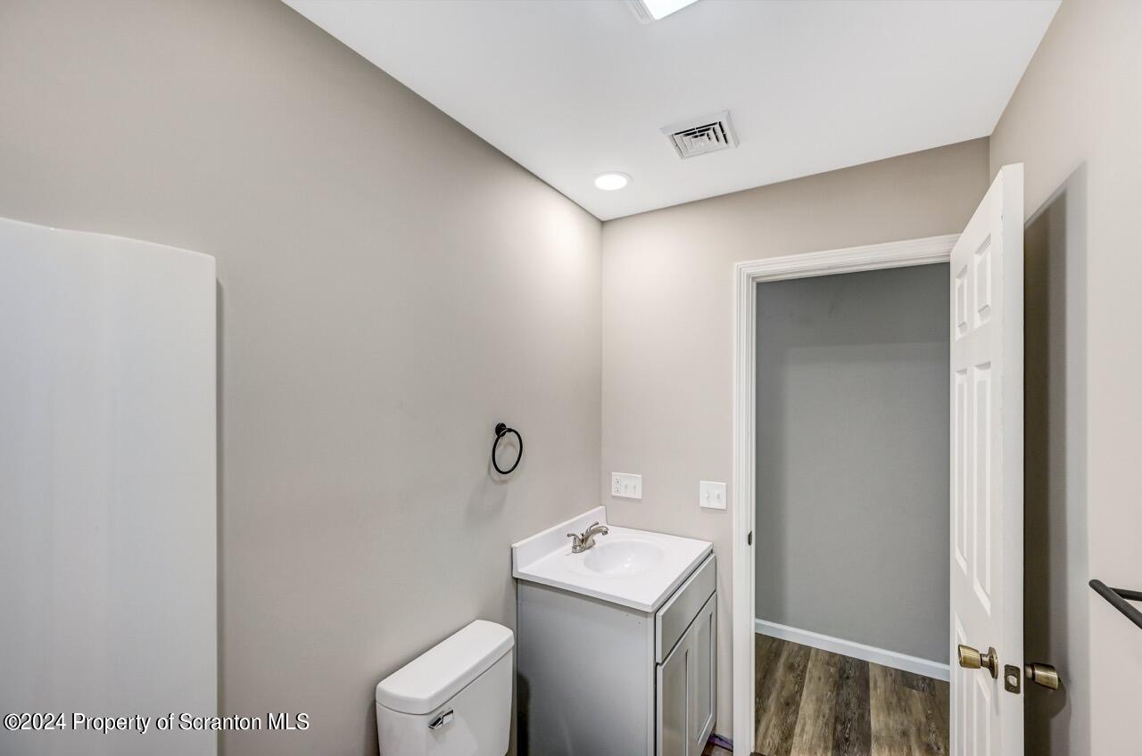 551 Back Street Scranton, PA 18504 - Photo 35 of 47 a bathroom with a toilet sink and mirror