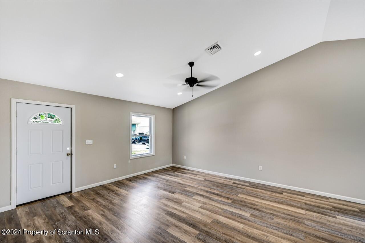 551 Back Street Scranton, PA 18504 - Photo 5 of 47 an empty room with wooden floor and windows