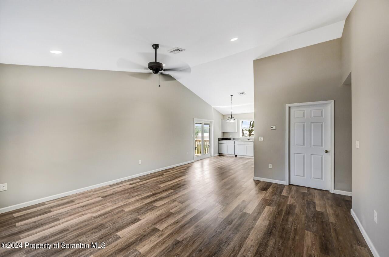 551 Back Street Scranton, PA 18504 - Photo 6 of 47 a view of a room with wooden floor and a ceiling fan