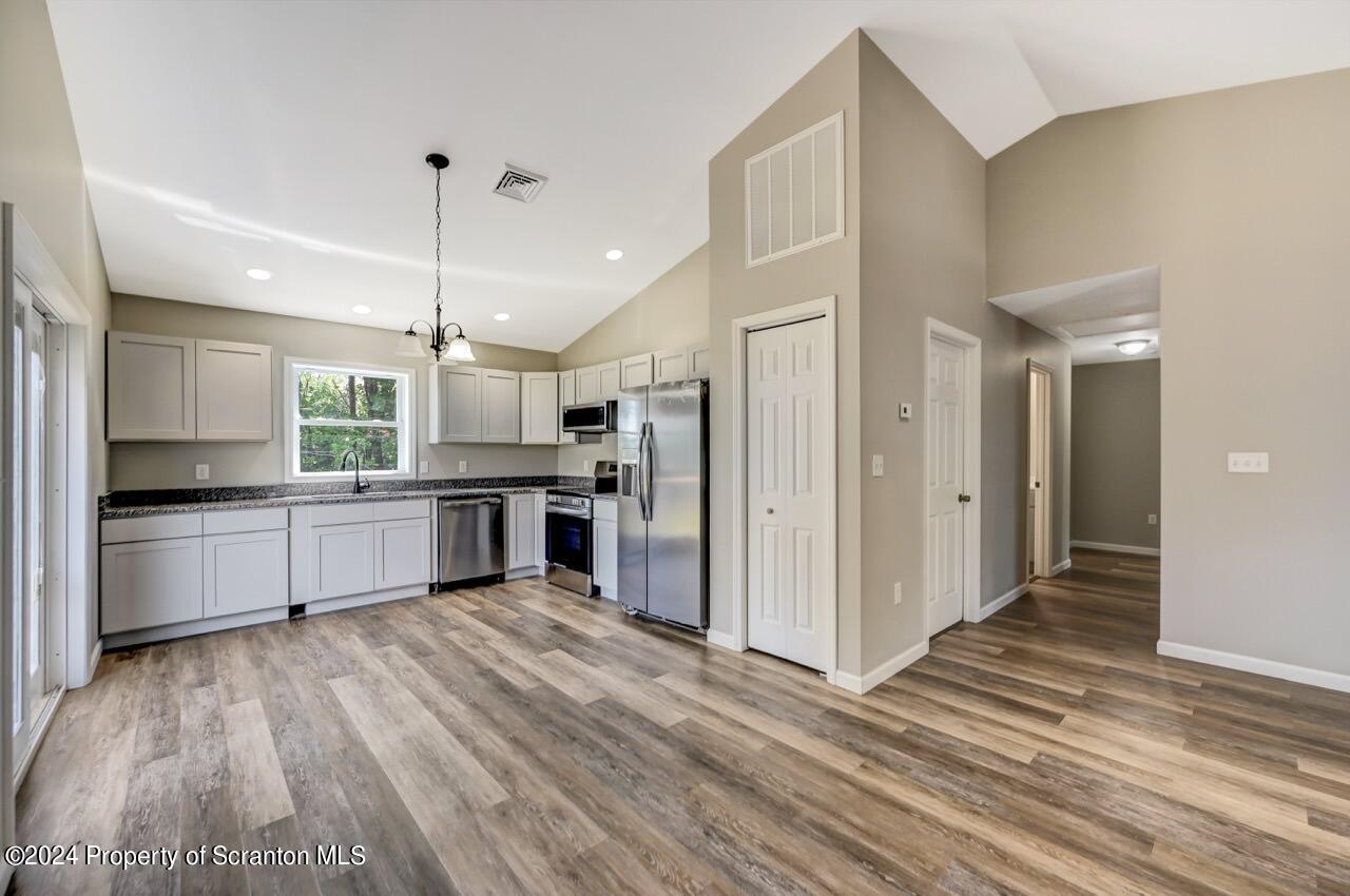551 Back Street Scranton, PA 18504 - Photo 10 of 47 a large kitchen with a center island wooden floor stainless steel appliances and cabinets