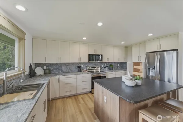 a bathroom with a shower sink and mirror