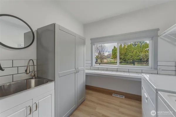 a bathroom with a toilet a sink and mirror