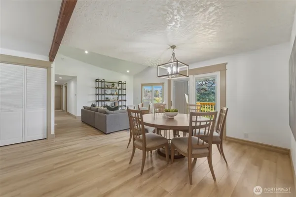 a kitchen with a refrigerator a stove a sink dishwasher and white cabinets with wooden floor