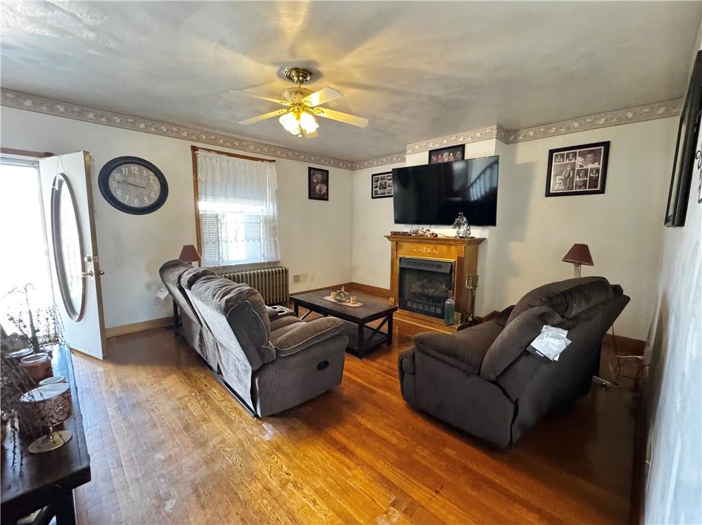 211 Stephens Street Vanderbilt, PA 15486 - Photo 12 of 48 a living room with furniture a flat screen tv and a fireplace