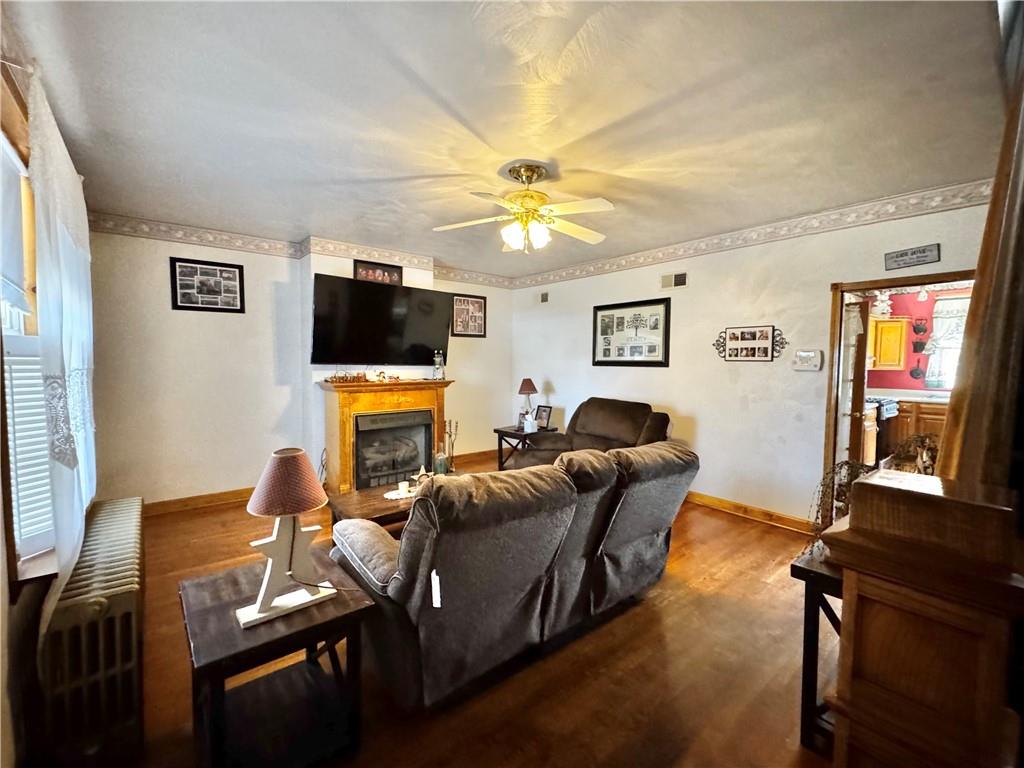 211 Stephens Street Vanderbilt, PA 15486 - Photo 15 of 48 a living room with furniture a flat screen tv and a fireplace