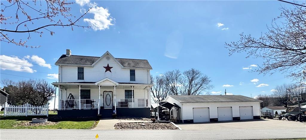 211 Stephens Street Vanderbilt, PA 15486 - Photo 2 of 48 a front view of a house with a yard and garage