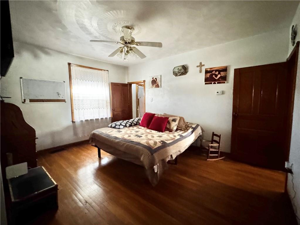 211 Stephens Street Vanderbilt, PA 15486 - Photo 28 of 48 a bedroom with a bed and wooden floor