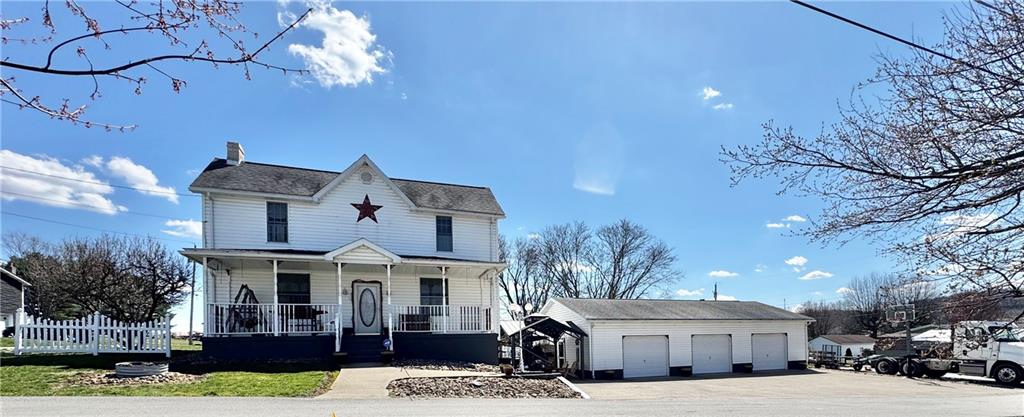 211 Stephens Street Vanderbilt, PA 15486 - Photo 3 of 48 a front view of a house with a yard and garage