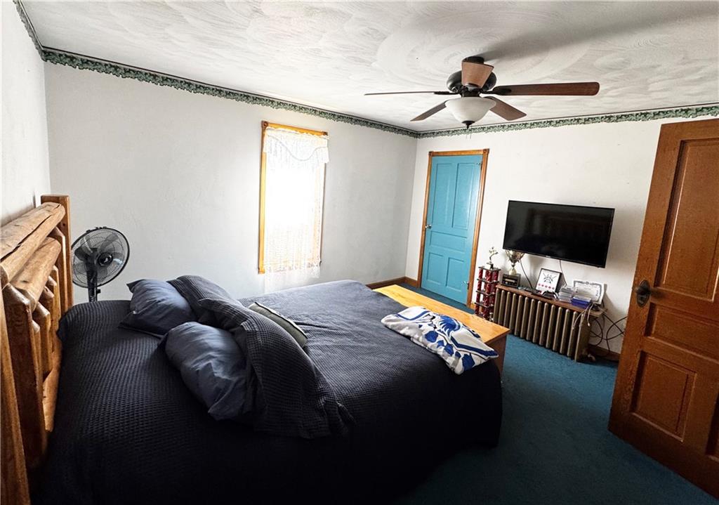 211 Stephens Street Vanderbilt, PA 15486 - Photo 34 of 48 a bedroom with a bed tv and a window