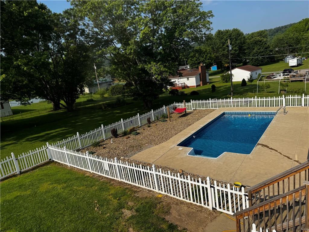 211 Stephens Street Vanderbilt, PA 15486 - Photo 4 of 48 a view of a balcony and floor to ceiling yard next to a yard and a large tree