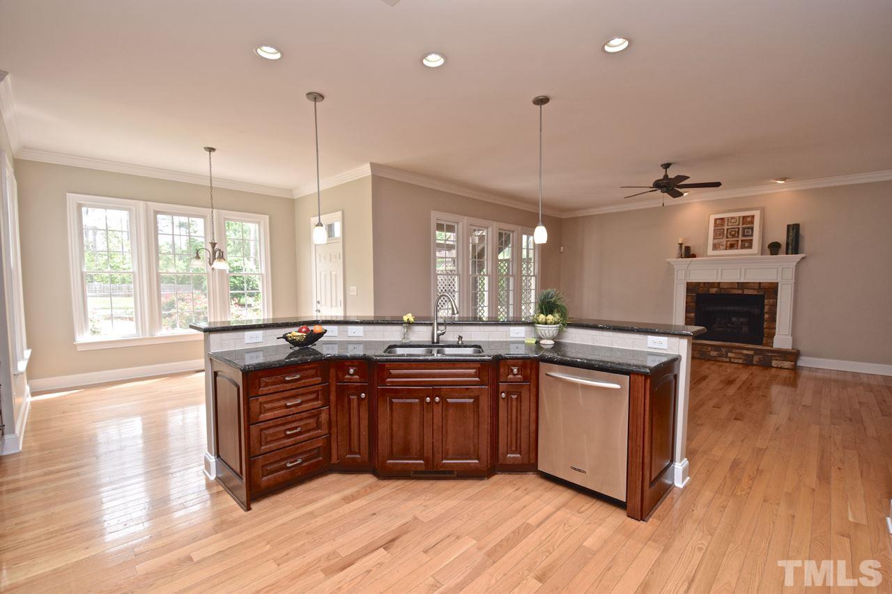 10320 Old Creedmoor Road Raleigh, NC 27613 - Photo 14 of 25 a kitchen with stainless steel appliances granite countertop wooden floors and sink