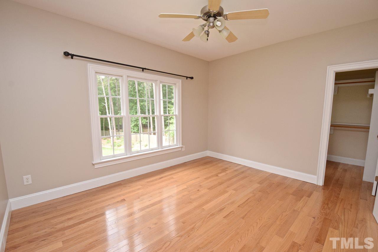 10320 Old Creedmoor Road Raleigh, NC 27613 - Photo 22 of 25 a view of an empty room with wooden floor and a window