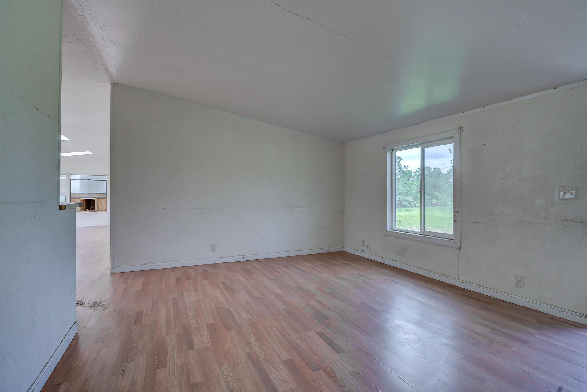 4450 Locust Road Anderson, CA 96007 - Photo 12 of 40 an empty room with wooden floor and windows