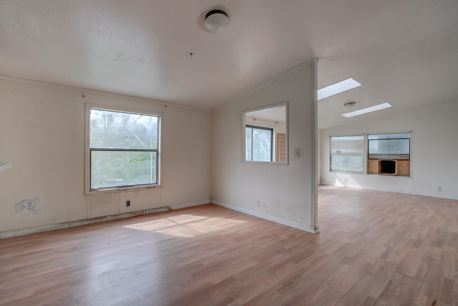 4450 Locust Road Anderson, CA 96007 - Photo 16 of 40 an empty room with wooden floor and windows