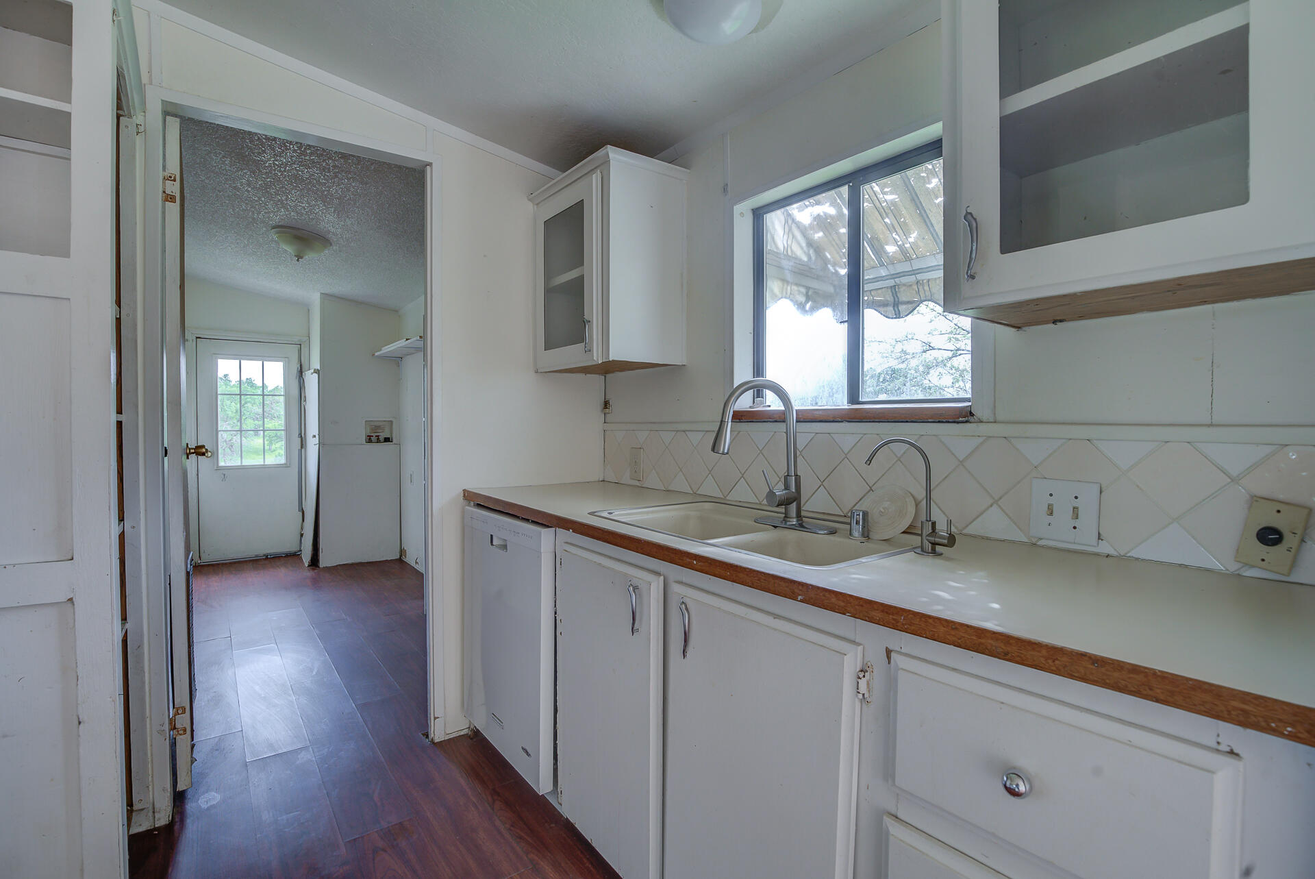 4450 Locust Road Anderson, CA 96007 - Photo 18 of 40 a kitchen with a sink cabinets and a window