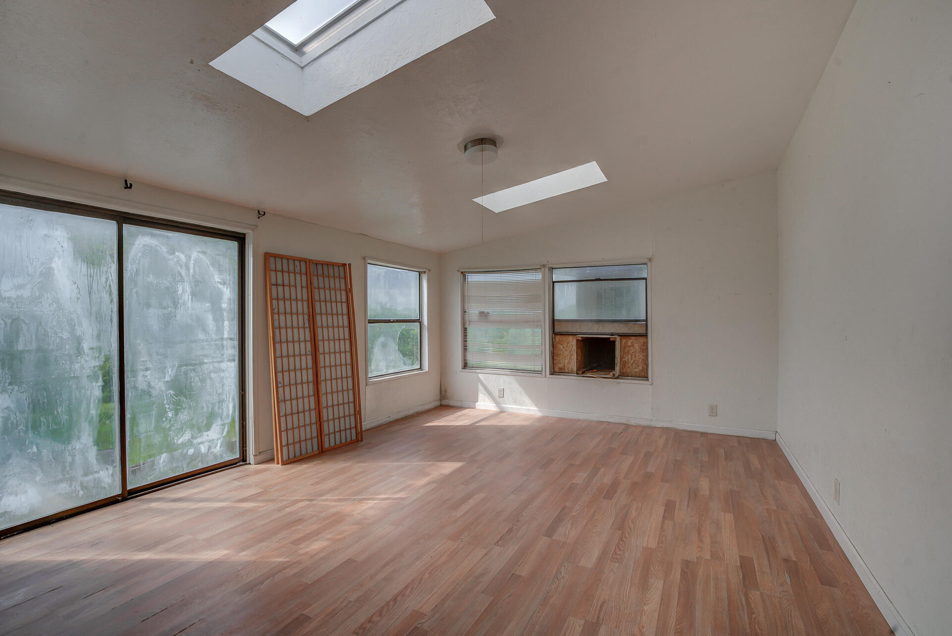 4450 Locust Road Anderson, CA 96007 - Photo 21 of 40 a view of an empty room with a window and wooden floor