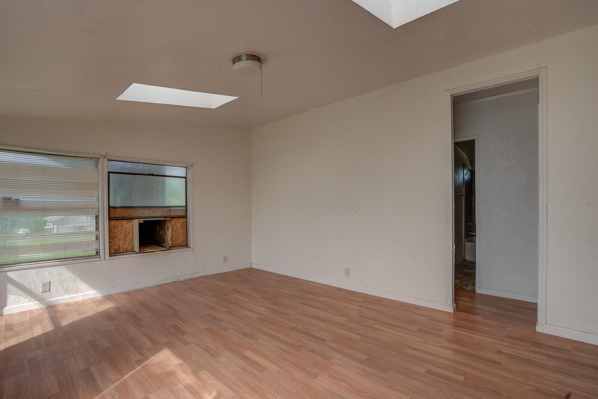 4450 Locust Road Anderson, CA 96007 - Photo 22 of 40 a view of an empty room with a window and fireplace