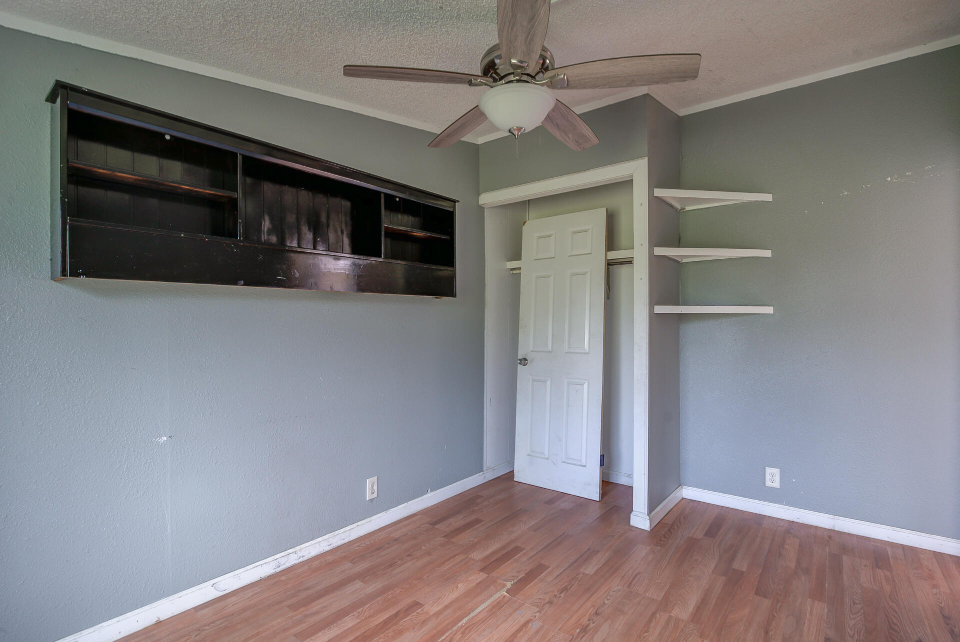 4450 Locust Road Anderson, CA 96007 - Photo 24 of 40 a view of an empty room with a fireplace and a window