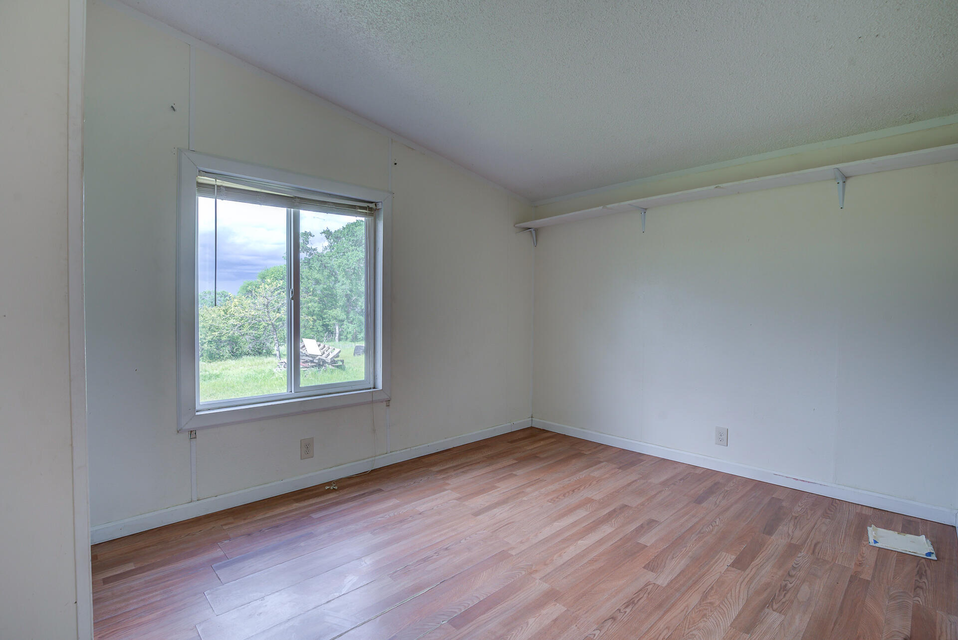 4450 Locust Road Anderson, CA 96007 - Photo 26 of 40 an empty room with wooden floor and windows