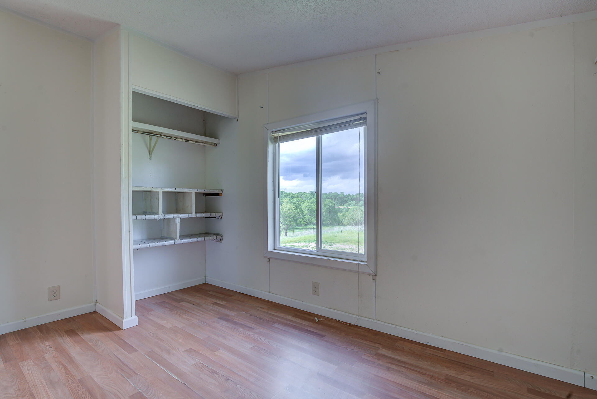 4450 Locust Road Anderson, CA 96007 - Photo 27 of 40 an empty room with wooden floor and window