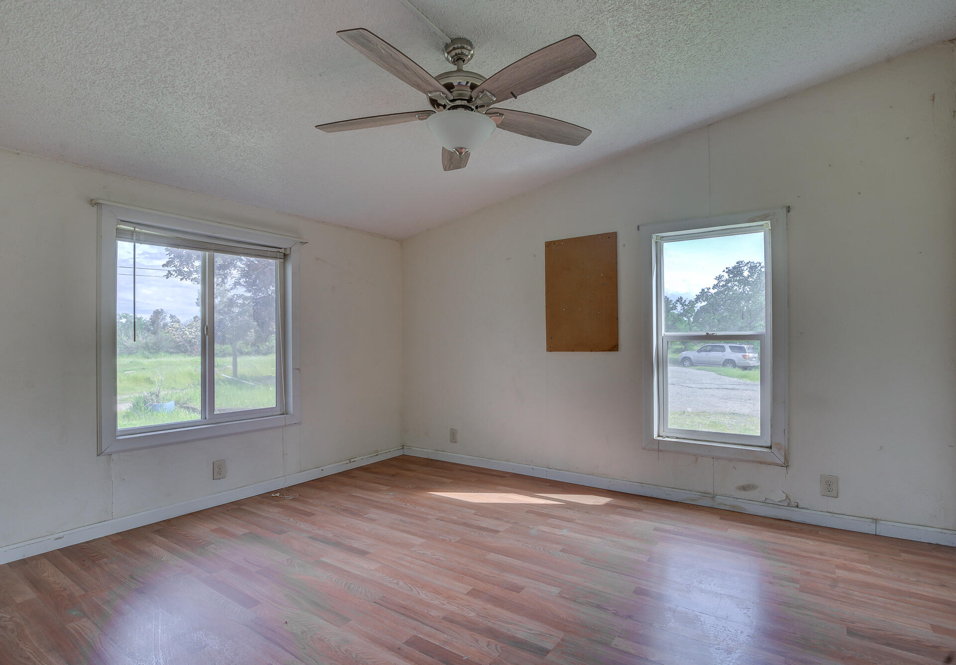 4450 Locust Road Anderson, CA 96007 - Photo 28 of 40 a view of an empty room with wooden floor and a window