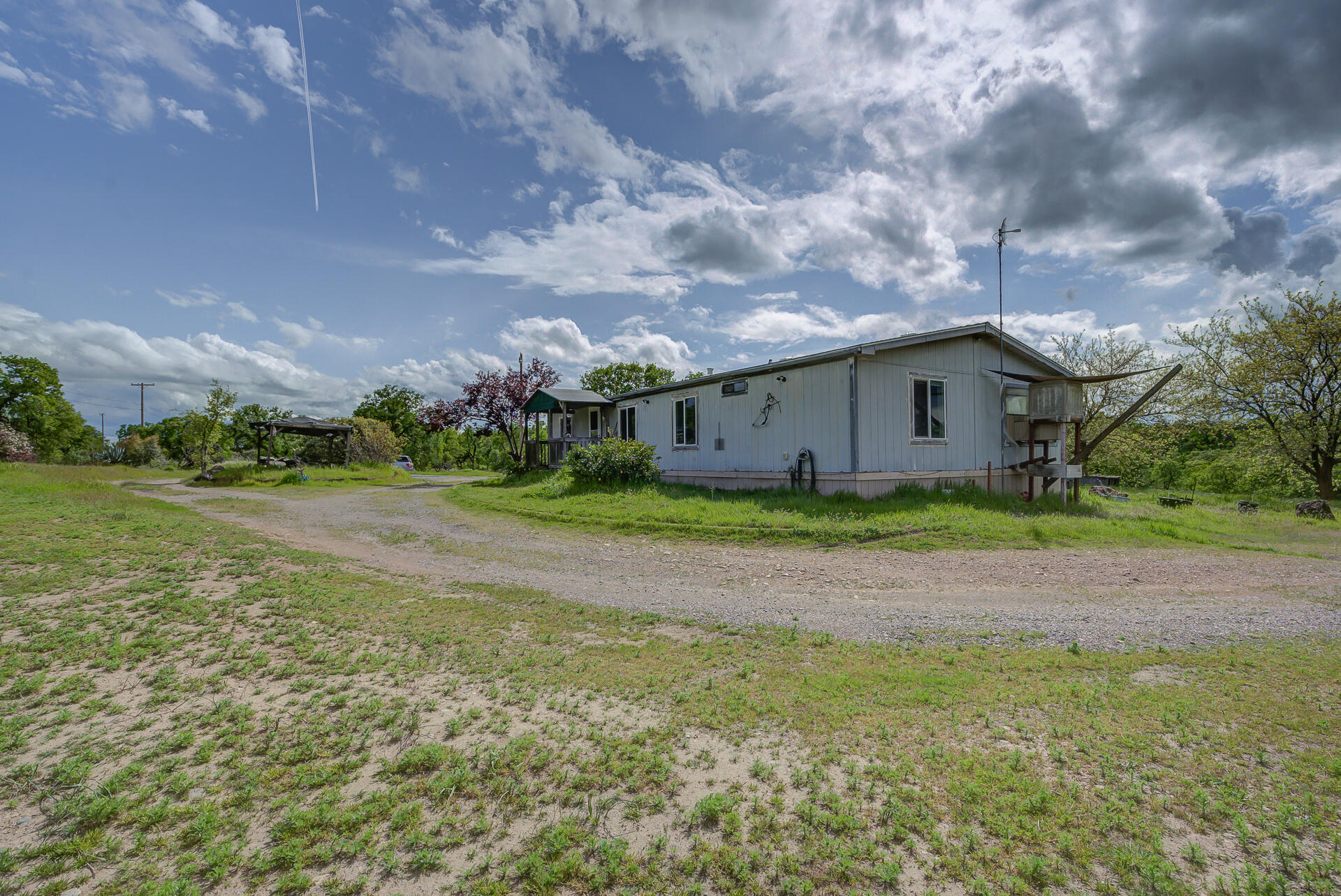 4450 Locust Road Anderson, CA 96007 - Photo 6 of 40 a view of an house with backyard space and garden