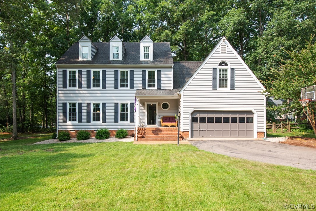 a view of a house with a yard and sitting area