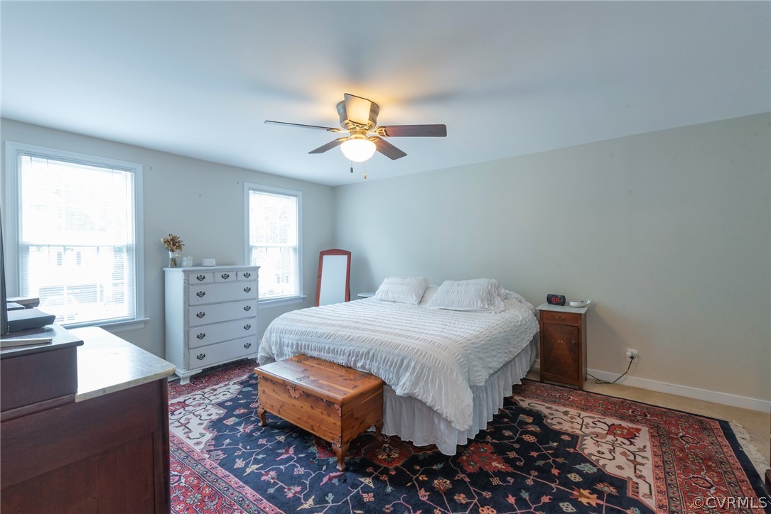 13810 Shadow Ridge Road Midlothian, VA 23112 - Photo 20 of 40 a bedroom with a bed and a chandelier