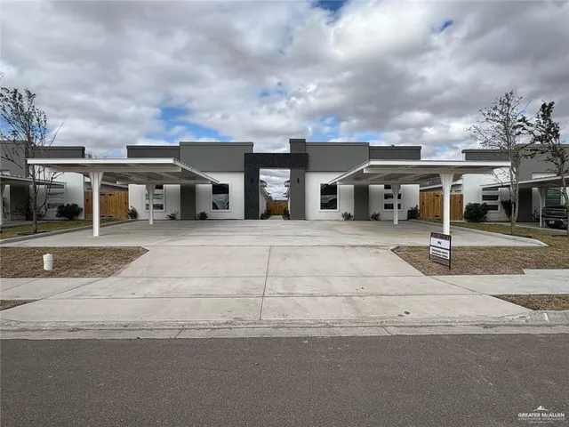 a front view of a house with a garden and barbeque oven
