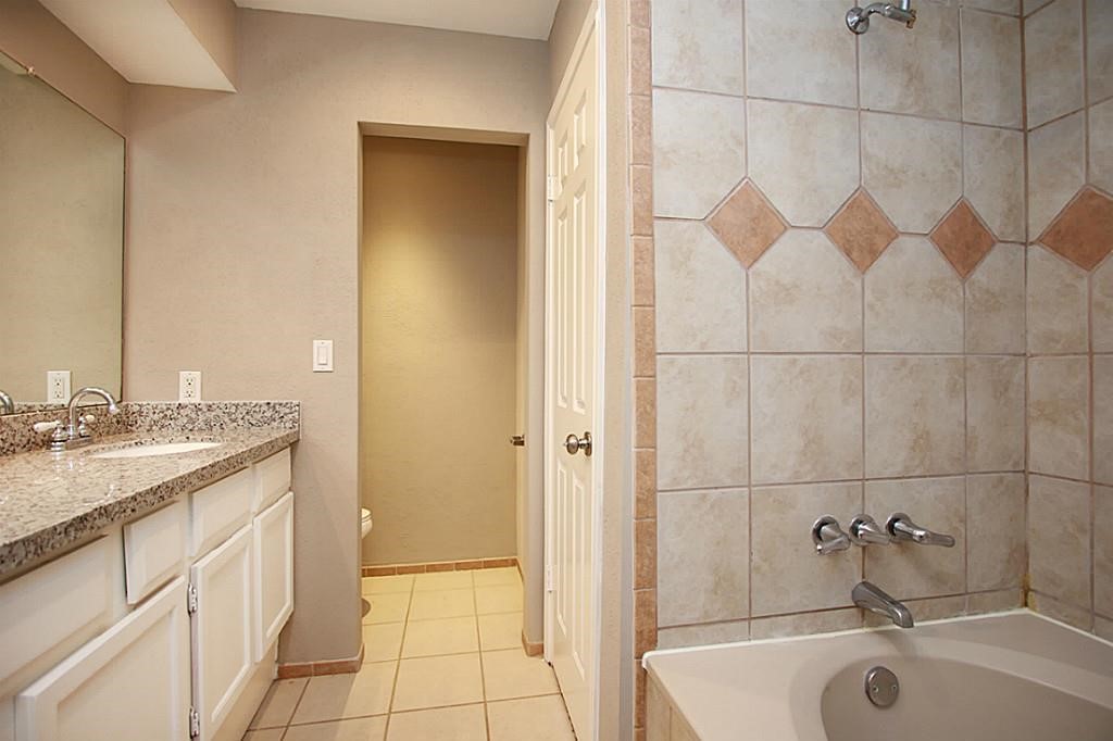 23315 Montague Drive Spring, TX 77373 - Photo 14 of 24 a bathroom with a granite countertop sink and a mirror