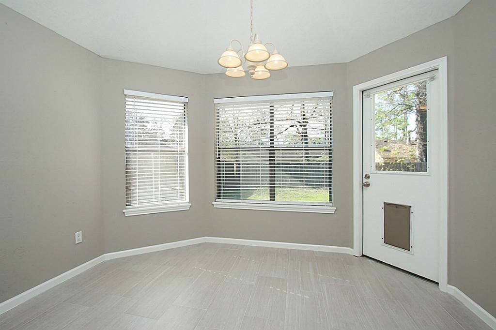 23315 Montague Drive Spring, TX 77373 - Photo 10 of 24 an empty room with windows and chandelier
