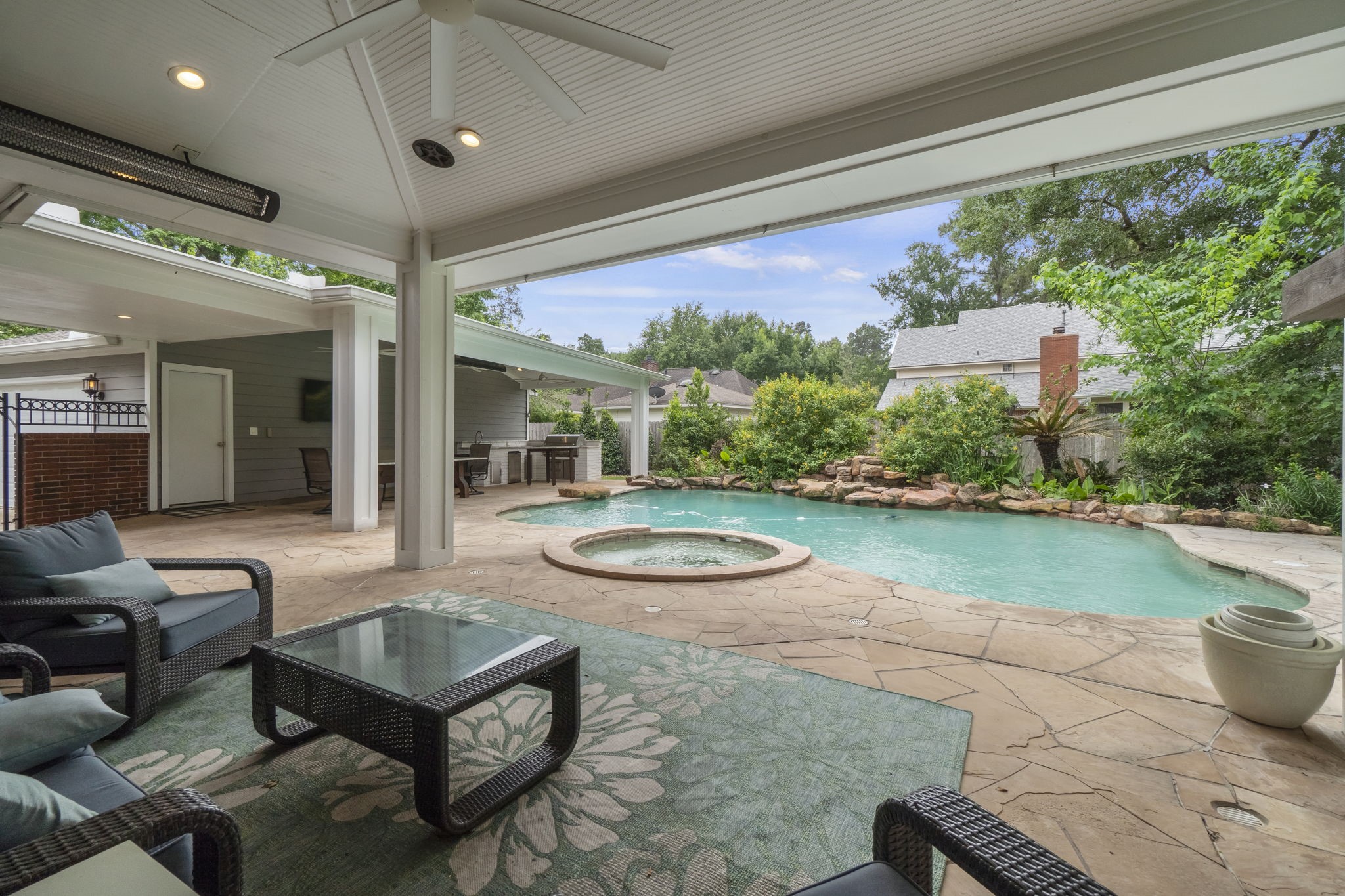 23 Rustic View Court The Woodlands, TX 77381 - Photo 2 of 18 Newly constructed covered outdoor kitchen, complete with gas grill, granite counter space,
custom built high top dining table and work station table