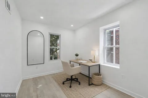 a view of a room with gym equipment and windows