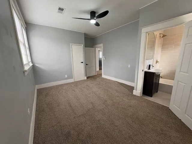 a view of a kitchen with furniture and stainless steel appliances