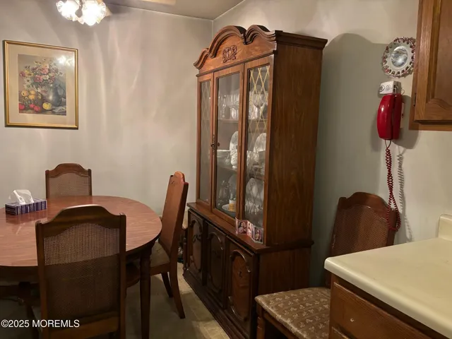 a view of a workspace with furniture and chandelier