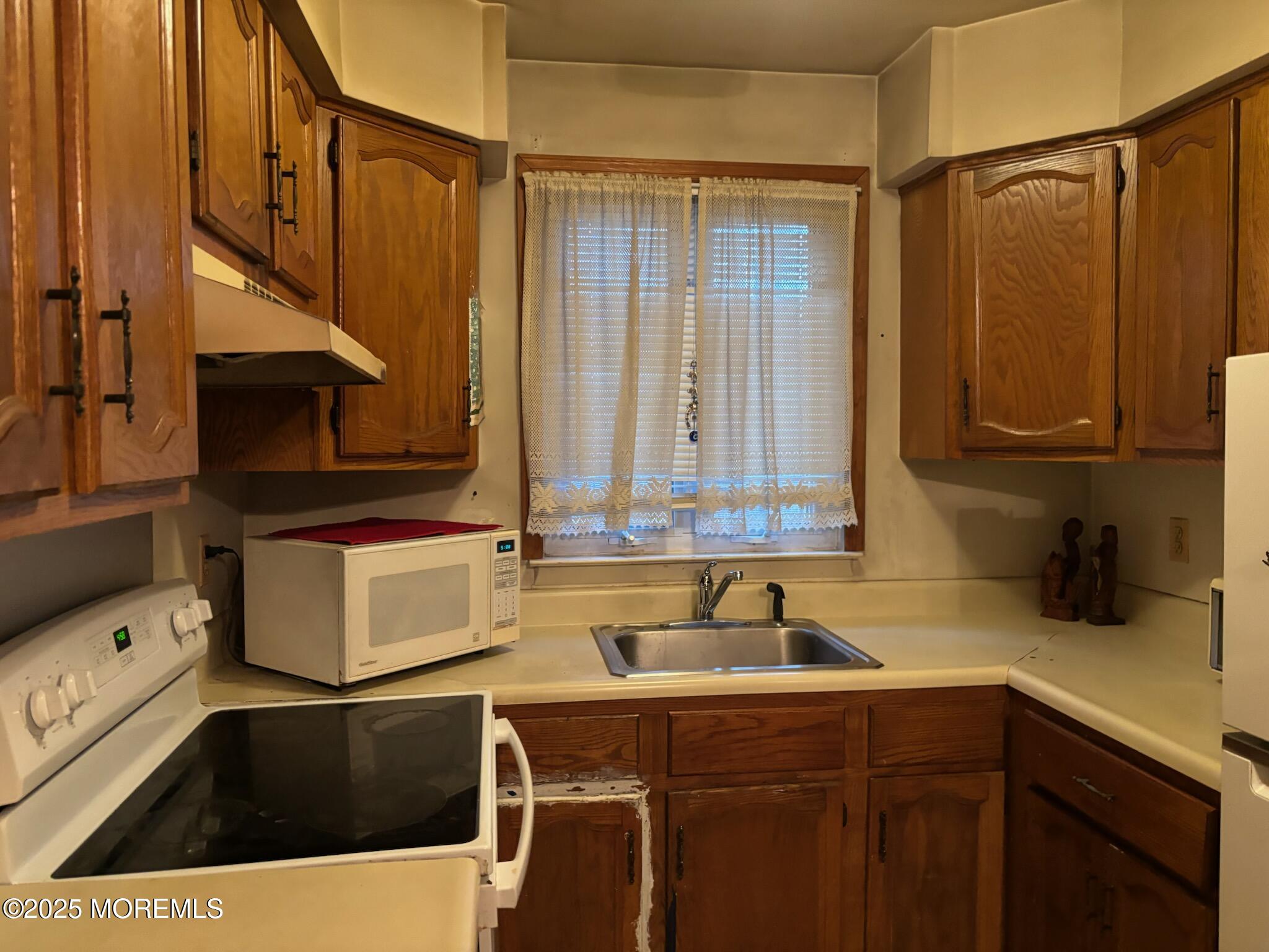 3 Swift Circle, Unit D Whiting, NJ 08759 - Photo 19 of 34 a kitchen with a sink a stove and cabinets