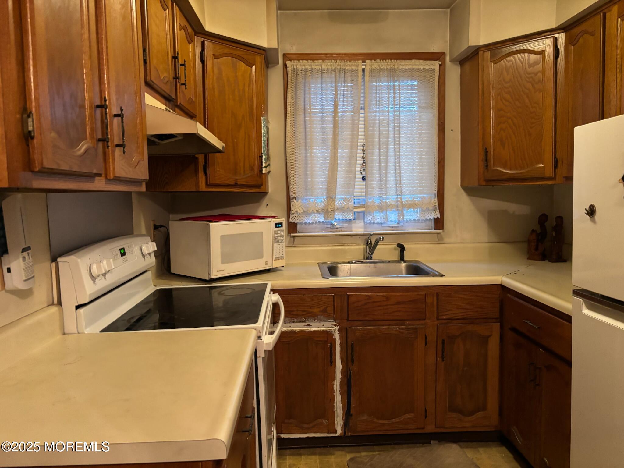 3 Swift Circle, Unit D Whiting, NJ 08759 - Photo 23 of 34 a kitchen with a sink a stove and cabinets