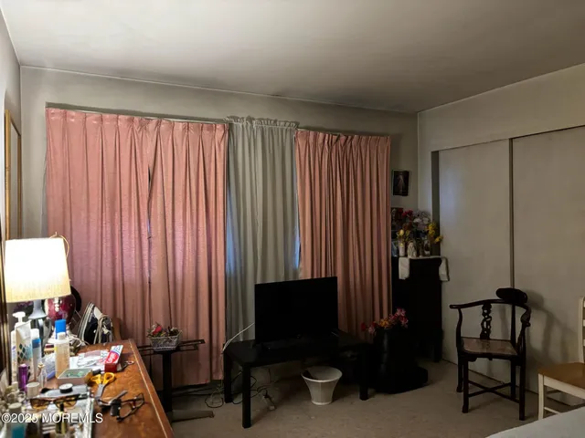 a view of a room with gym equipment and a window