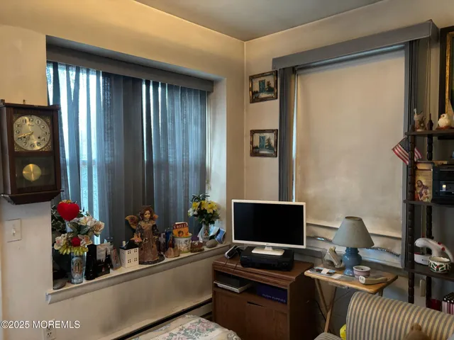 a view of a workspace with furniture and a window