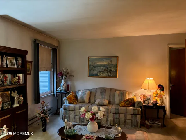 a living room with furniture a lamp and a bookshelf