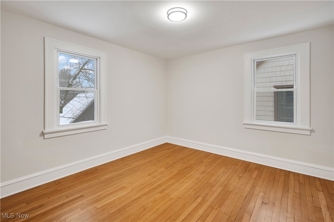 2016 Rossmoor Road Cleveland Heights, OH 44118 - Photo 32 of 46 Empty room featuring baseboards and hardwood / wood-style floors