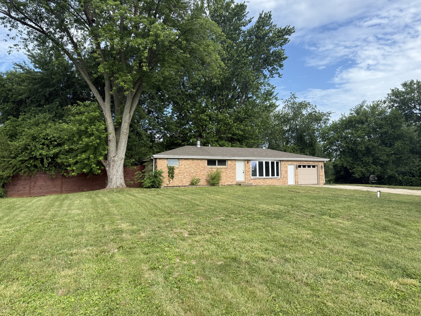a house that is sitting in the middle of tall trees