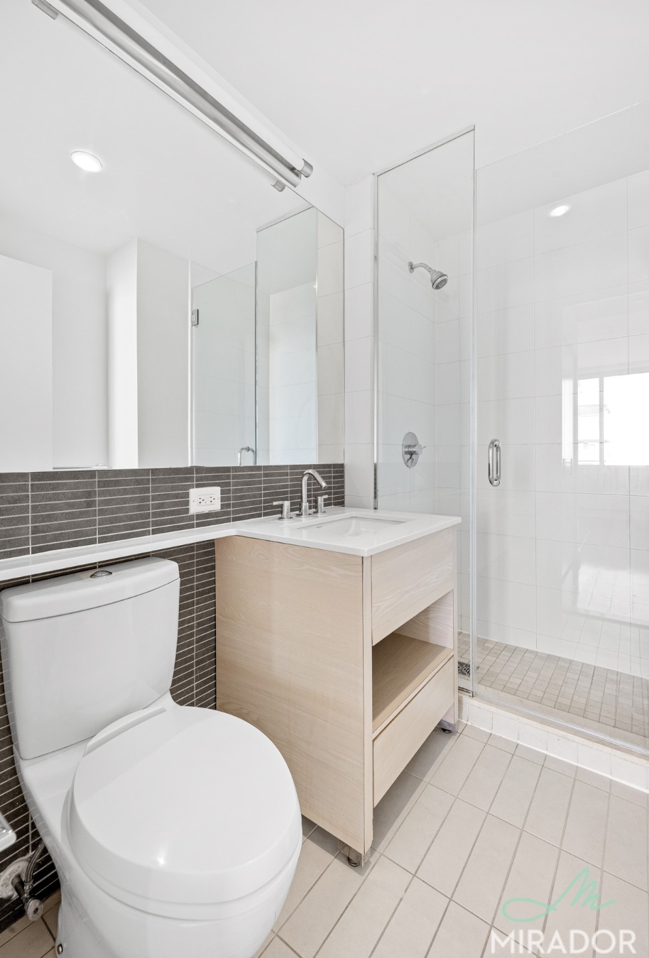 80 Dekalb Avenue, Unit 30C Brooklyn, NY 11201 - Photo 15 of 28 a bathroom with a toilet sink and mirror