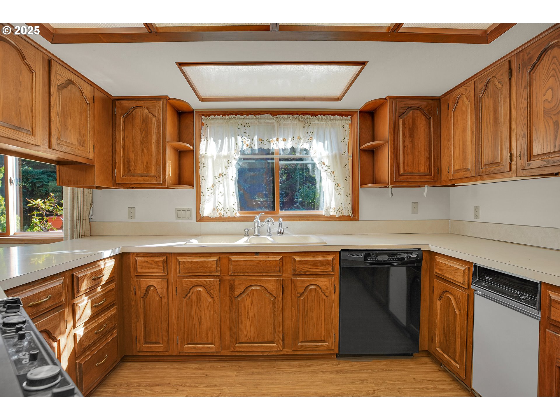 8710 Southeast 57th Avenue Portland, OR 97206 - Photo 20 of 47 a kitchen with stainless steel appliances granite countertop a sink dishwasher stove and cabinets with wooden floor
