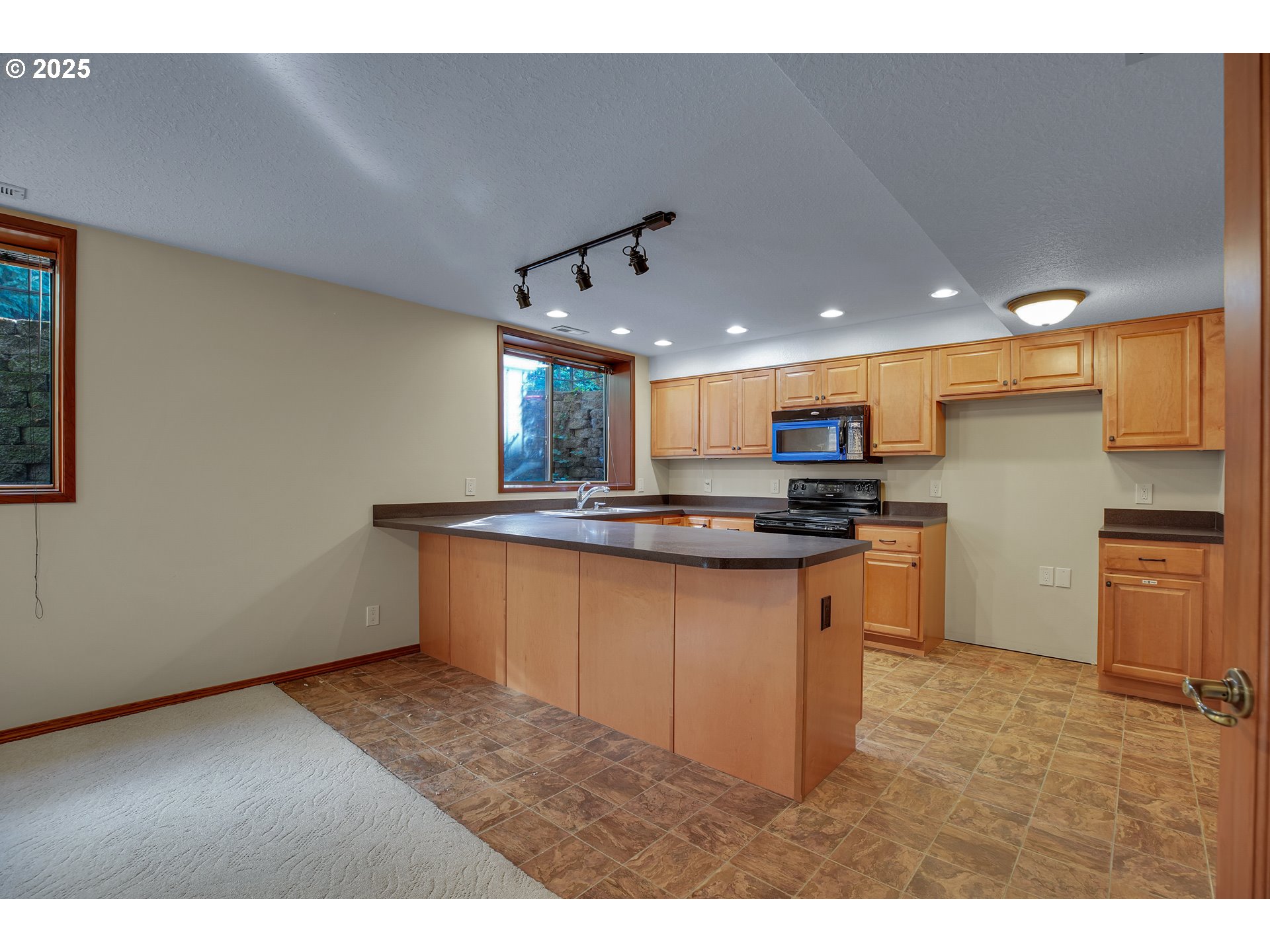 8710 Southeast 57th Avenue Portland, OR 97206 - Photo 30 of 47 a kitchen with stainless steel appliances kitchen island sink stove and refrigerator