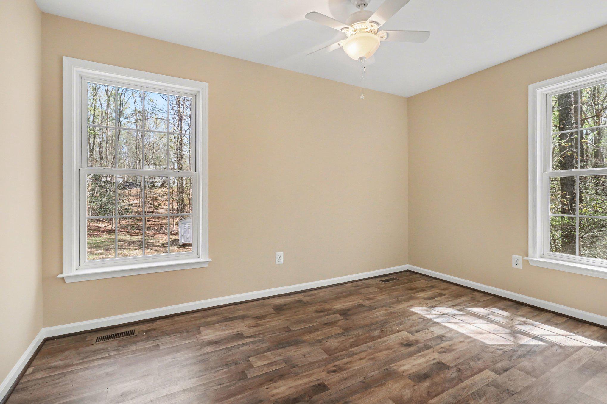 876 Campers Lane Ruther Glen, VA 22546 - Photo 12 of 27 a view of an empty room with wooden floor and a window