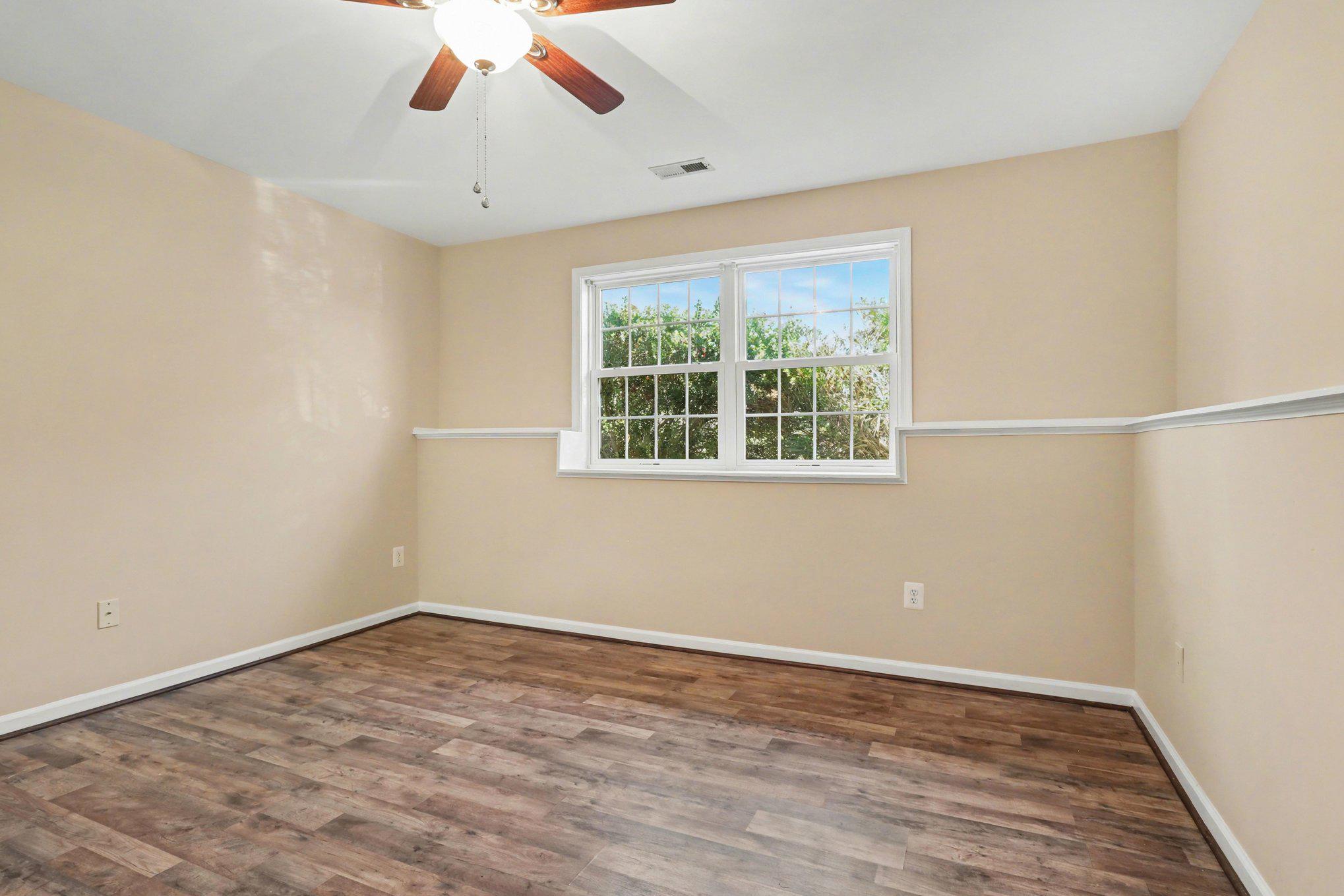 876 Campers Lane Ruther Glen, VA 22546 - Photo 13 of 27 a view of empty room with wooden floor and fan