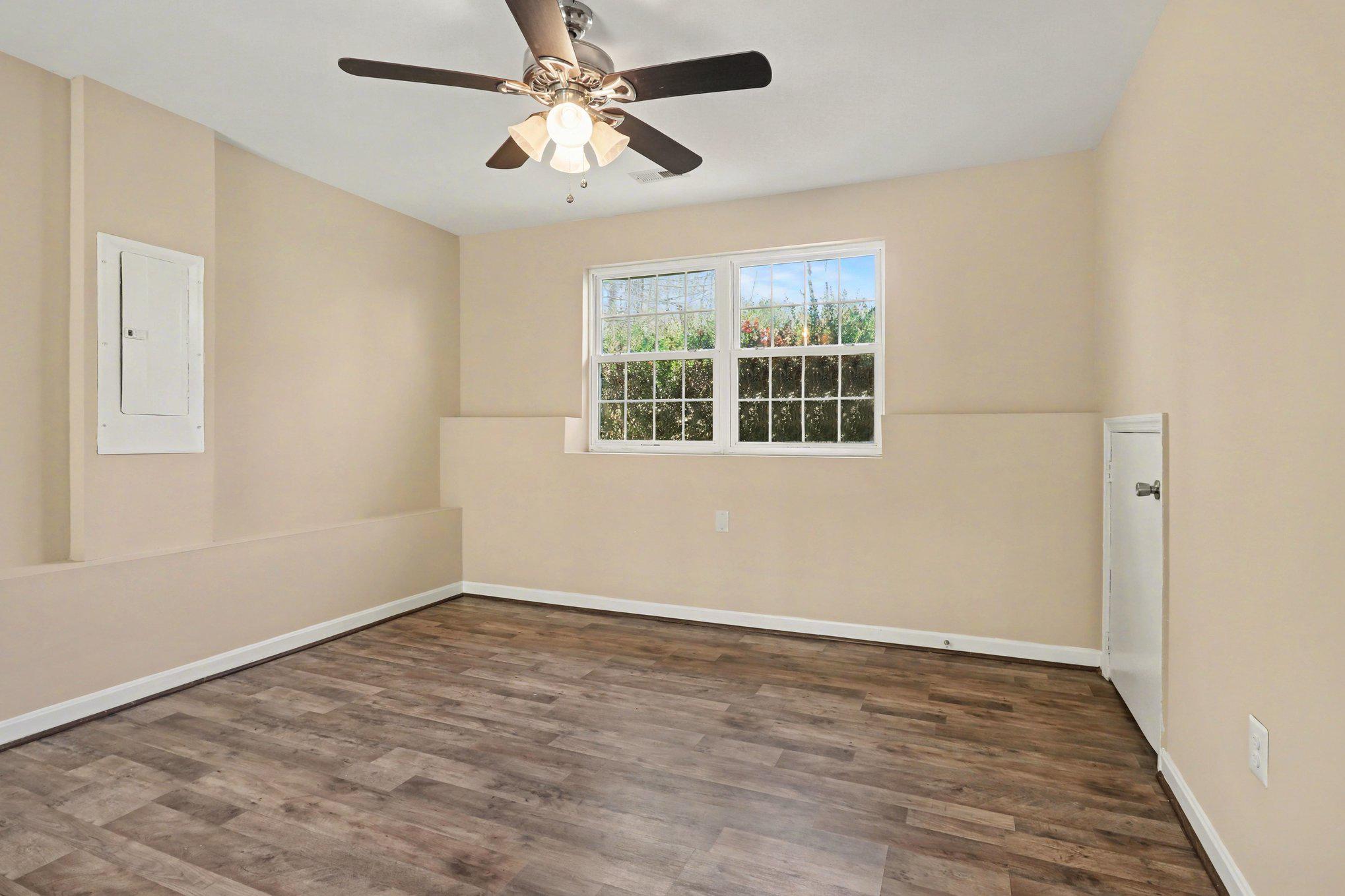 876 Campers Lane Ruther Glen, VA 22546 - Photo 17 of 27 a view of empty room with wooden floor and fan