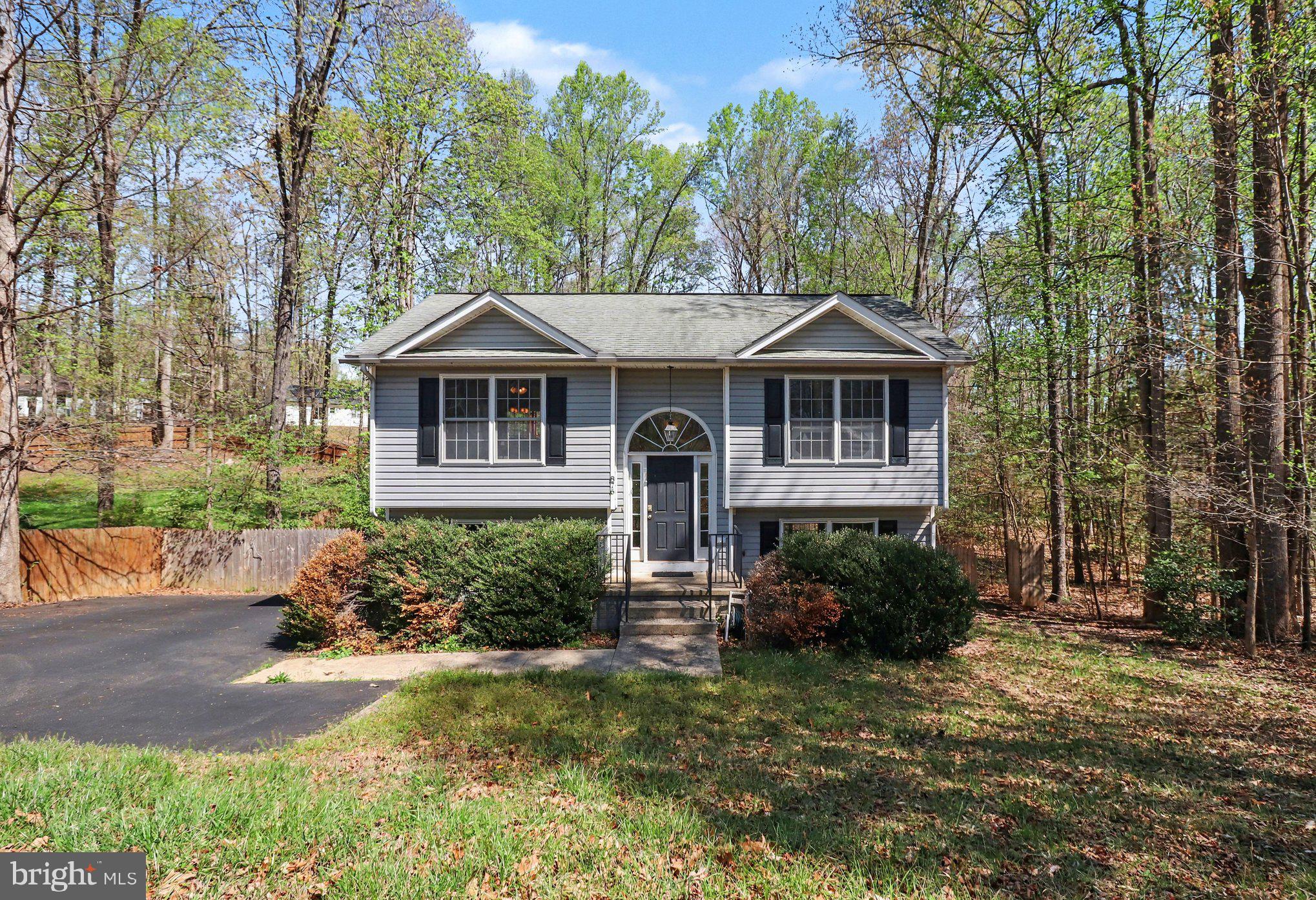 876 Campers Lane Ruther Glen, VA 22546 - Photo 2 of 27 a front view of a house with a yard